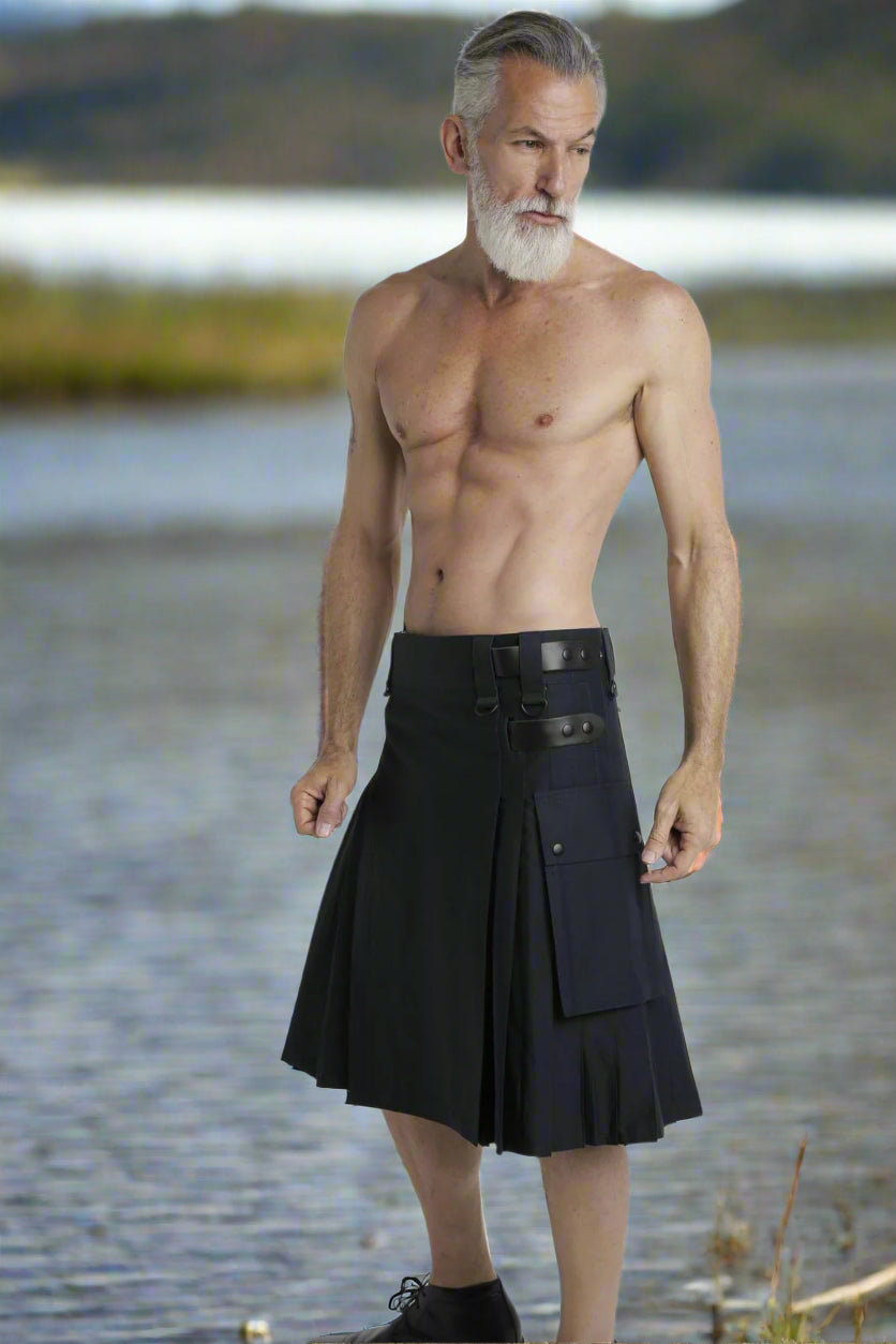 Man wearing a black kilt on a white background