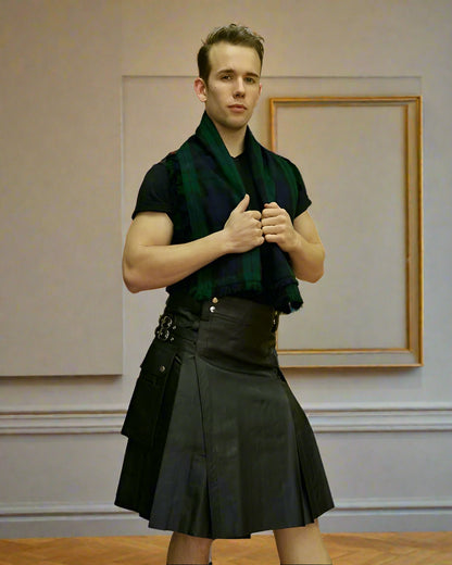 Man wearing a kilt and tartan scarf on a plain background